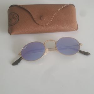 Ray Ban Sunglasses with purple lenses and gold frame.
